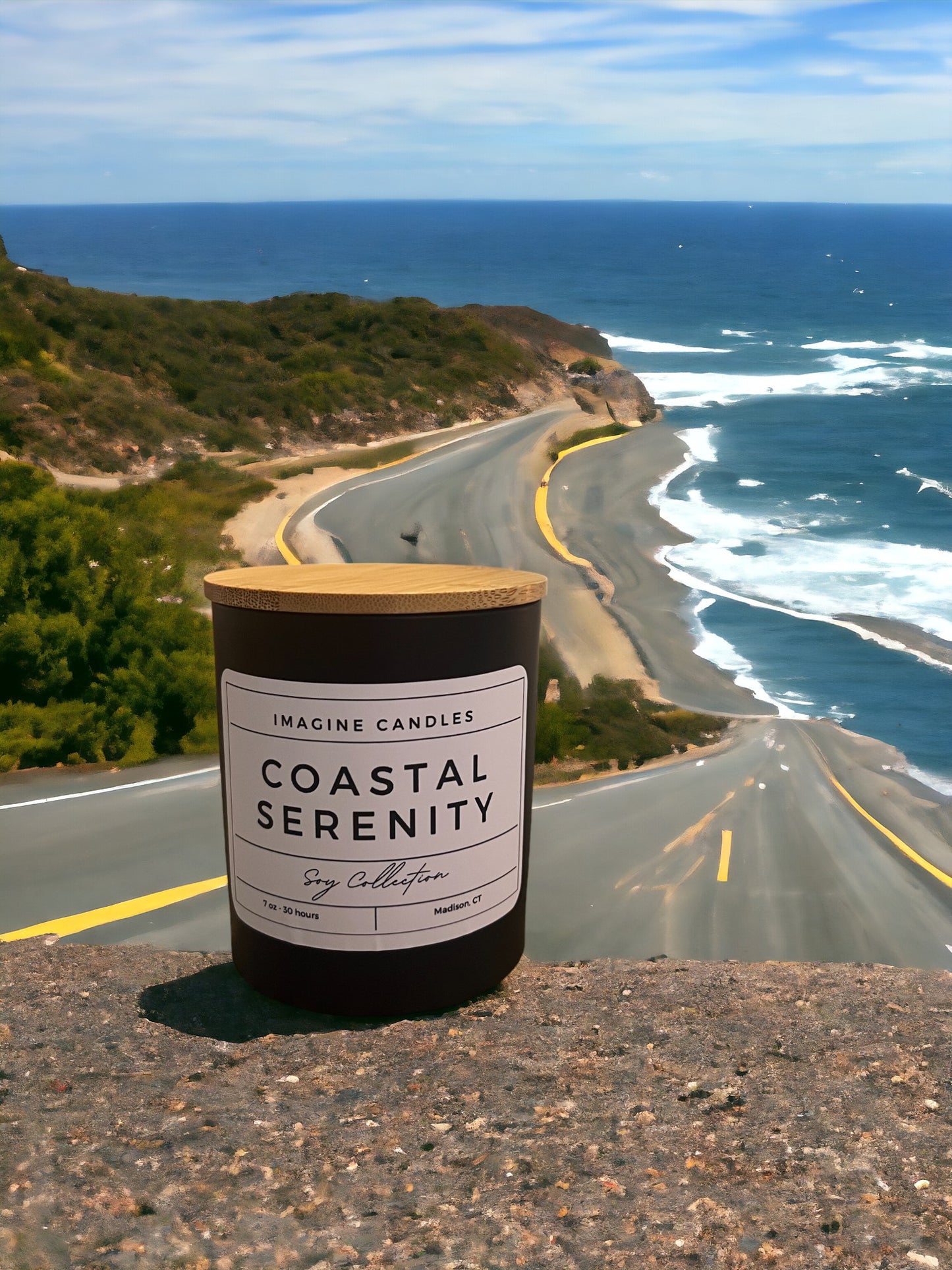 A candle sits on a ledge overlooking a road leading to a serene beach. The label reads 'Coastal Serenity', evoking the tranquil ambiance of a beach walk. The fragrance notes include marine, apple, honeydew melon, jasmine, lily of the valley, musk, and sandalwood. Infused with natural essential oils, including sweet orange.