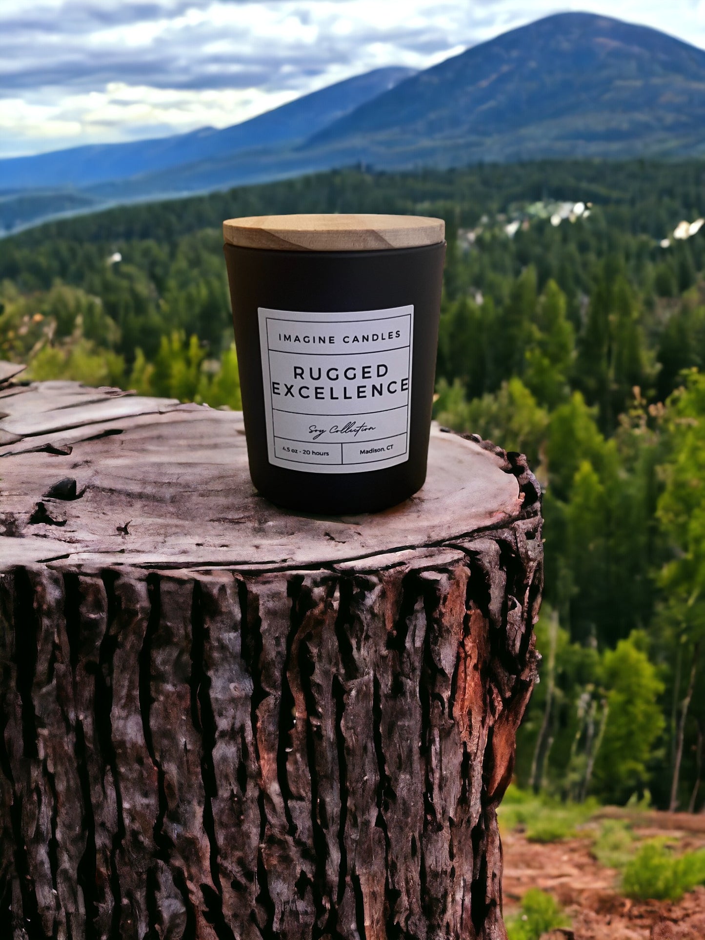 A candle rests on a stump overlooking the woods, embodying the essence of Rugged Excellence. The label reads 'Rugged Excellence', evoking the feeling of a long day and the comfort of a favorite cologne. Fragrance notes include petitgrain, cardamom, lemon, orange, fir, jasmine, rosemary, rose, lily of the valley, vetiver, musk, oak moss, and Brazilian rosewood."