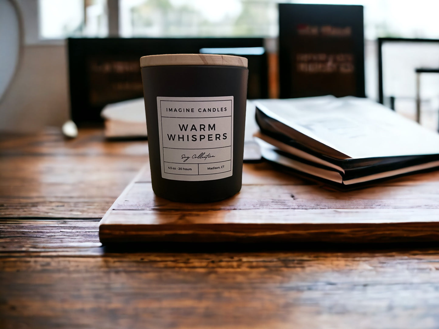 A candle sits on a table with a drink and a book, embodying the essence of Warm Whispers. The label reads 'Warm Whispers', evoking the feeling of excitement and energy. Fragrance notes include petitgrain, orange, grapefruit, cotton blossom, coconut, musk, powder, and wood, infused with natural essential oils, including orange peel, juniper, grapefruit peel, lemon peel, and tangerine."