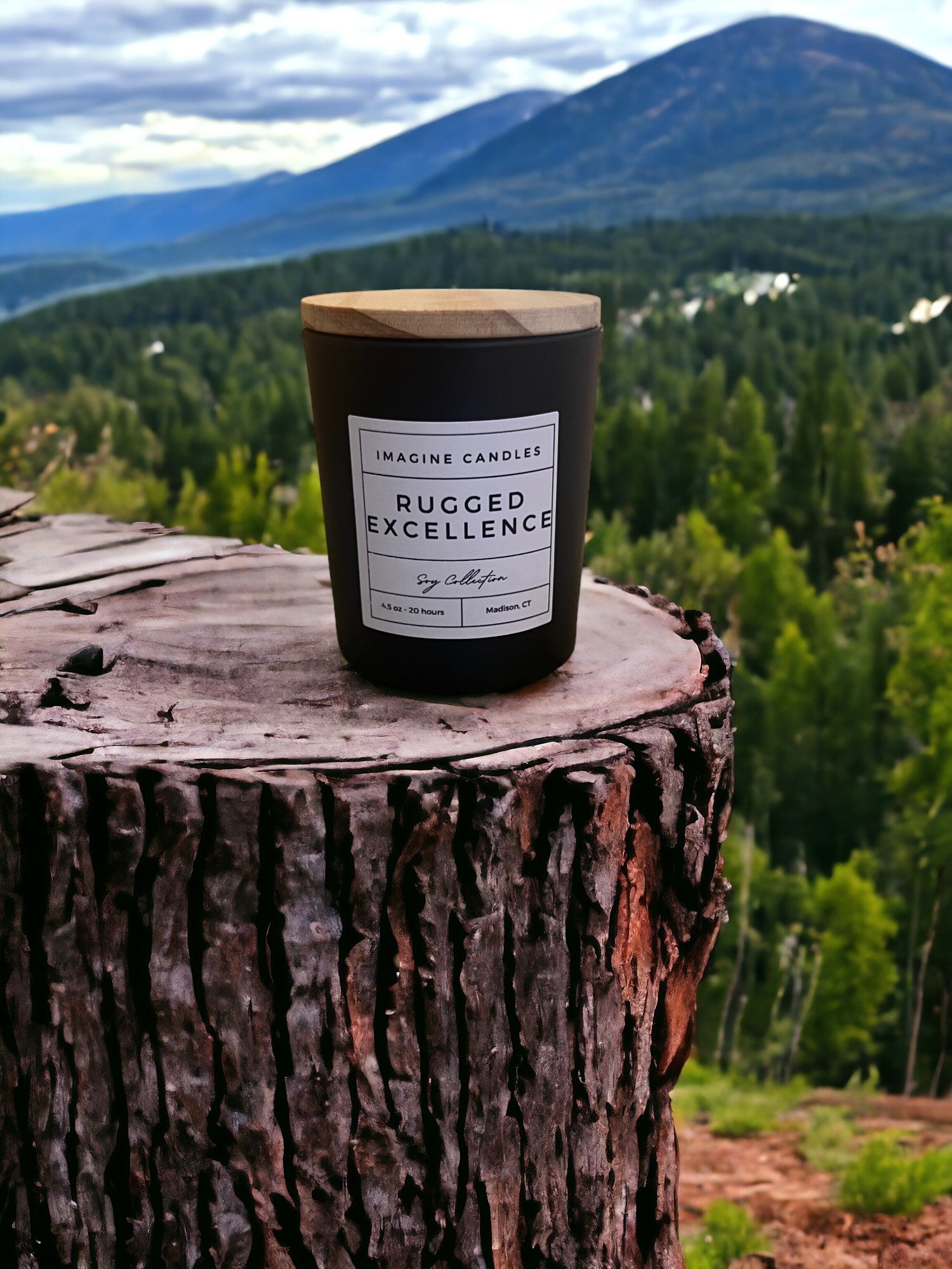 A candle rests on a stump overlooking the woods, embodying the essence of Rugged Excellence. The label reads 'Rugged Excellence', evoking the feeling of a long day and the comfort of a favorite cologne. Fragrance notes include petitgrain, cardamom, lemon, orange, fir, jasmine, rosemary, rose, lily of the valley, vetiver, musk, oak moss, and Brazilian rosewood."